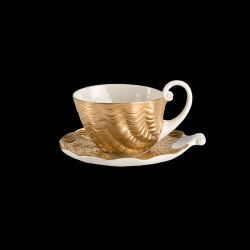Golden porcelain tea cup and saucer