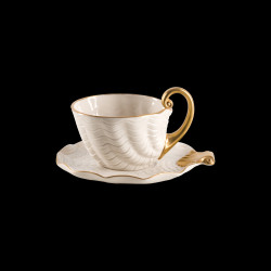 Cream and gold porcelain tea cup and saucer